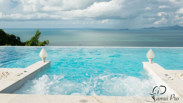 A infinity pool with clear blue water, a view of the sea, and a cloudy sky. - 12 Bedroom Luxury Twin Sea View Villas Angthong (Koh Samui)
