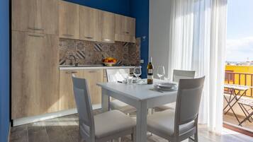 Deluxe Apartment, 1 Bedroom, Sea View | Private kitchen | Oven, stovetop, highchair, cookware/dishes/utensils