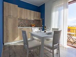 Deluxe Apartment, 1 Bedroom, Sea View | Private kitchen | Oven, stovetop, high chair, cookware/dishes/utensils