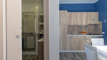 Deluxe Apartment, 1 Bedroom, Sea View | Private kitchen | Oven, stovetop, highchair, cookware/dishes/utensils