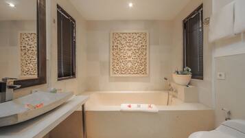 A bathroom with a bathtub, a sink, and a toilet.