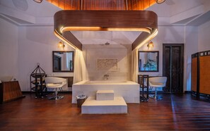 A modern bathroom with a central sink, two side mirrors, a wooden ceiling design, and a large mirror above the sink.