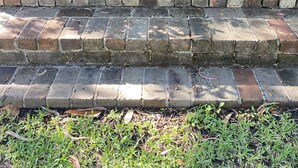 A set of brick steps leading up to a brick wall, surrounded by greenery and potted plants. - Studio minutes from Waterfront walks, close to Pasadenas, cafes, restaurants  (Bayview)