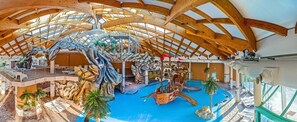 A spacious atrium with a high wooden ceiling, a central water feature, and multiple levels with balconies. - Mediteran Mobile Homes in Terme Catez (Brezice)