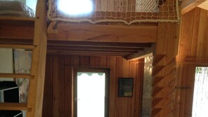 A wooden interior with a loft bed, a small table, and a window. - cottage: nature and lavender (la rochette du buis)
