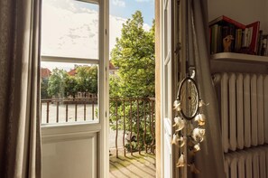 Enjoy a peaceful retreat with a balcony offering a view, a dreamcatcher, and a cozy reading nook.