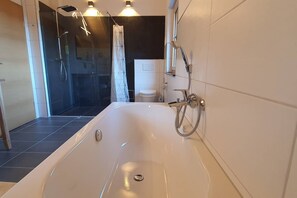 Bathtub, hair dryer, towels, soap