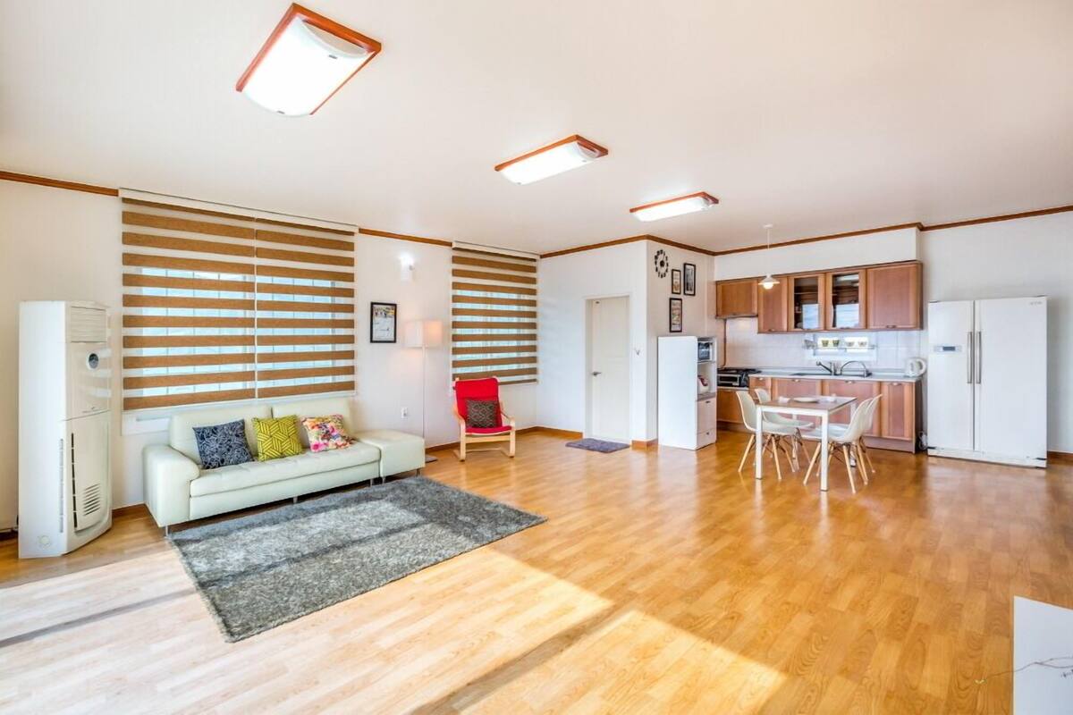 A modern apartment with a living room, kitchen, and dining area.
