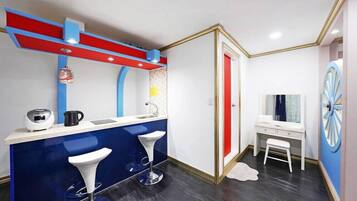 Un baño moderno con tocador azul, lavabo blanco y una pared de acento roja.
