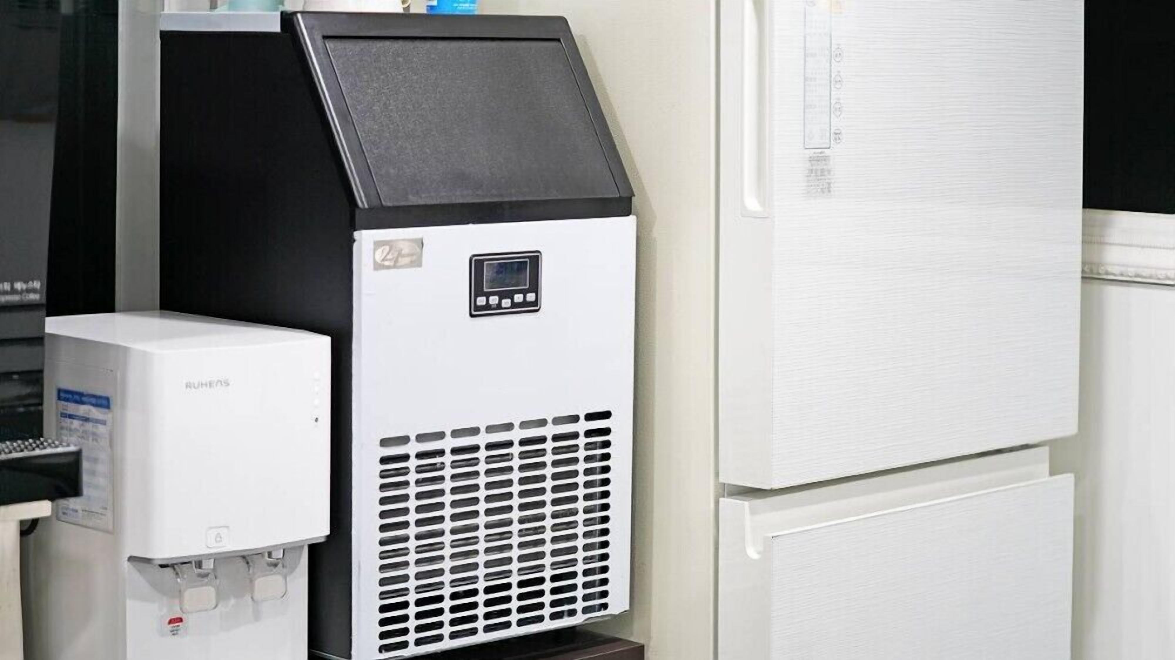 A beverage dispenser and a refrigerator in a commercial setting.