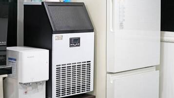 A beverage dispenser and a refrigerator in a commercial setting.
