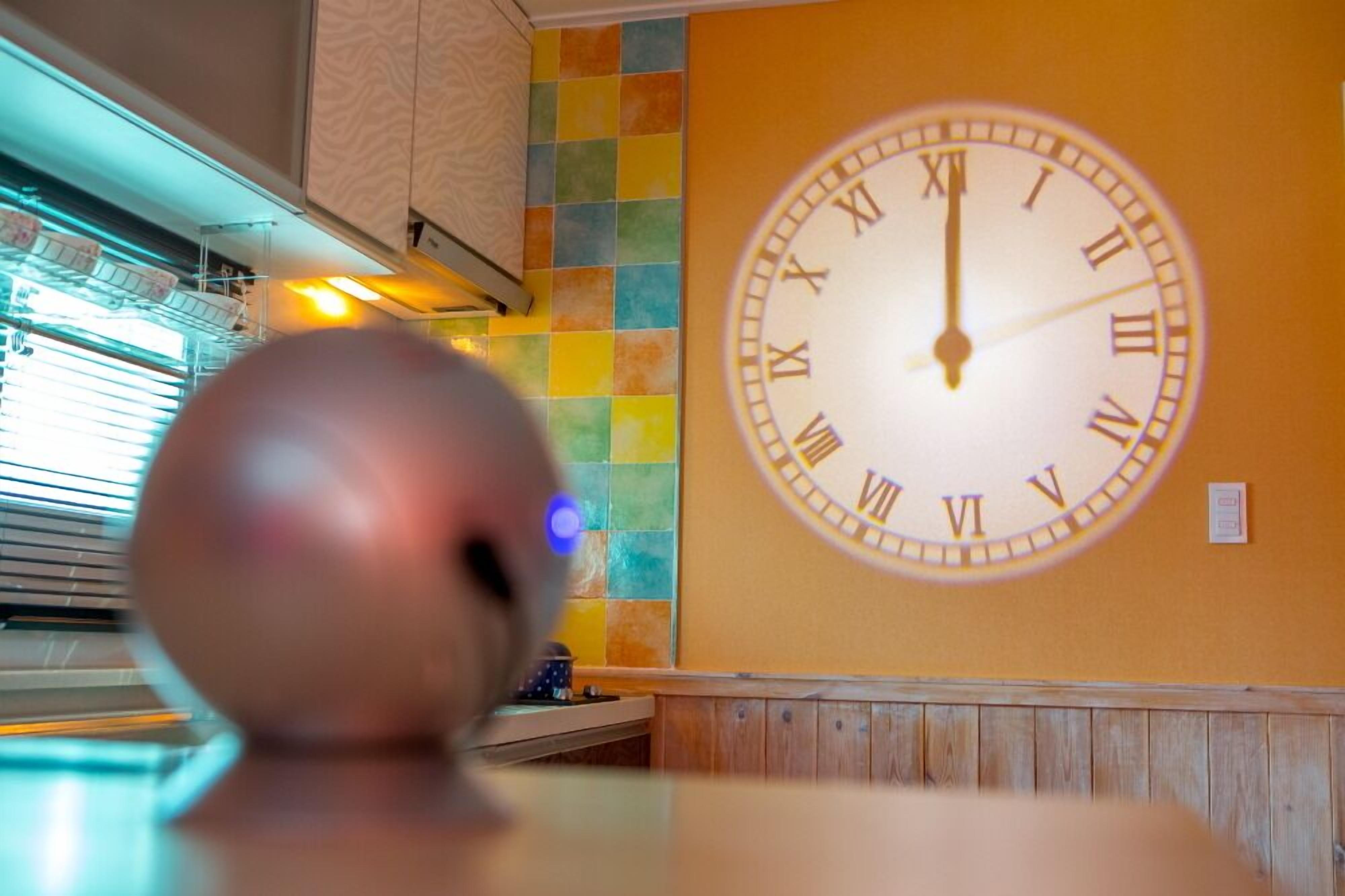 A clock on a wall with Roman numerals.