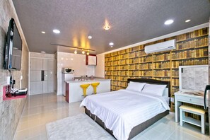 A modern bedroom with a large bed, a built-in desk, and a bookshelf. - Huenest pension (Gapyeong)
