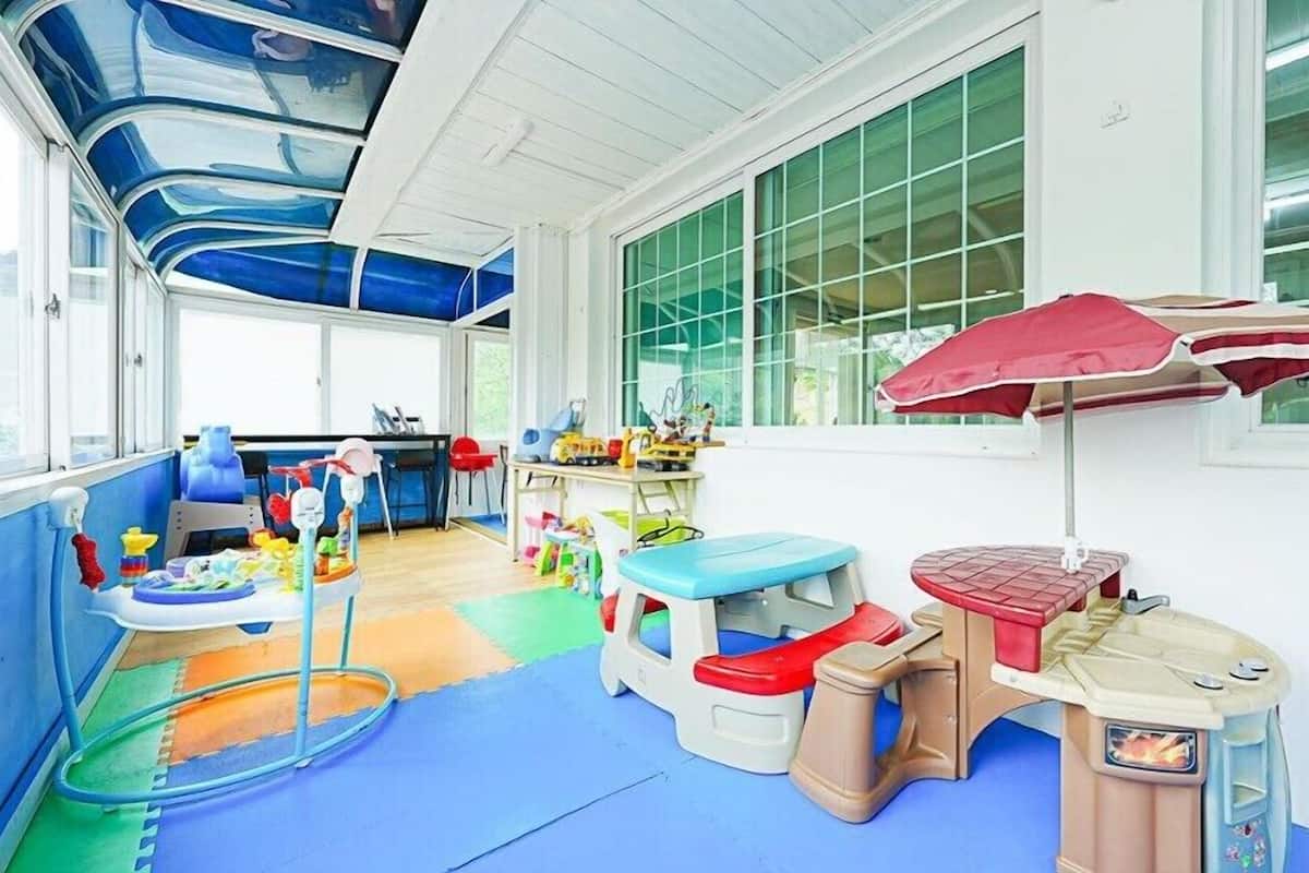 A children's play area with colorful furniture and toys.