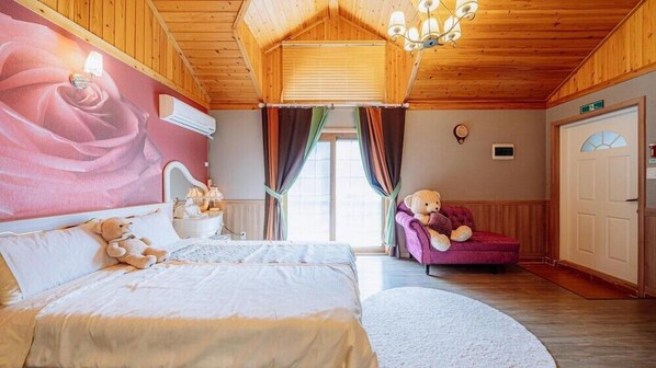 A cozy room with a bed, a chair, a teddy bear, and a large window with curtains.
