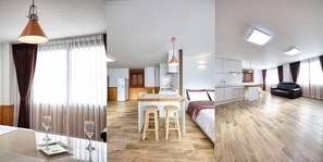 Une chambre d’hôtel moderne dotée d’un coin repas, d’une cuisine et d’un vaste espace de vie.