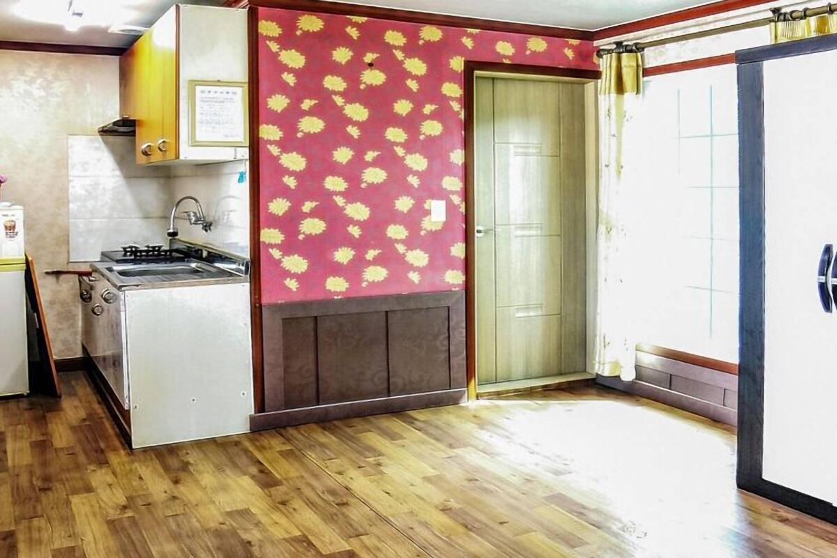 A compact kitchen with a refrigerator, stove, and sink.