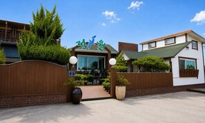 A building with a sign that reads 'Hotel' and a wooden fence with a gate. - Jeongwon Pension (Pohang)