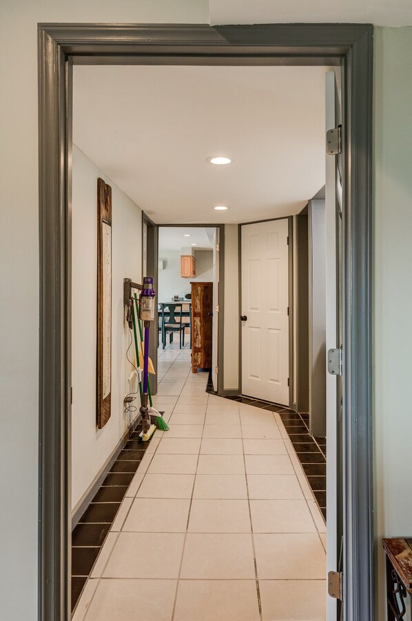 Enter a serene hallway leading to a room with a door.