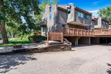 Front unit with windows on 3 sides and 2 car carport directly underneath unit.