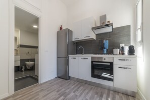 Apartment, 2 Bedrooms | Private kitchen | Full-size fridge, stovetop, dishwasher, coffee/tea maker