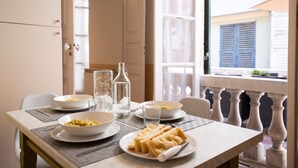 A dining table set with bowls of food, a bottle, and a plate of waffles. - Family Apartments Angeli (Genoa)