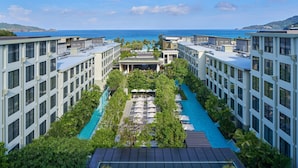 A modern hotel with a pool, multiple floors, and a view of the ocean. - Four Points by Sheraton Phuket Patong Beach Resort (Patong)