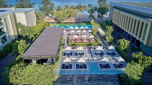 A resort with a rooftop pool, sun loungers, and a view of the ocean. - Four Points by Sheraton Phuket Patong Beach Resort (Patong)