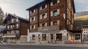 A multi-story wooden hotel with balconies and stone accents. - Hotel Dufour (Macugnaga)
