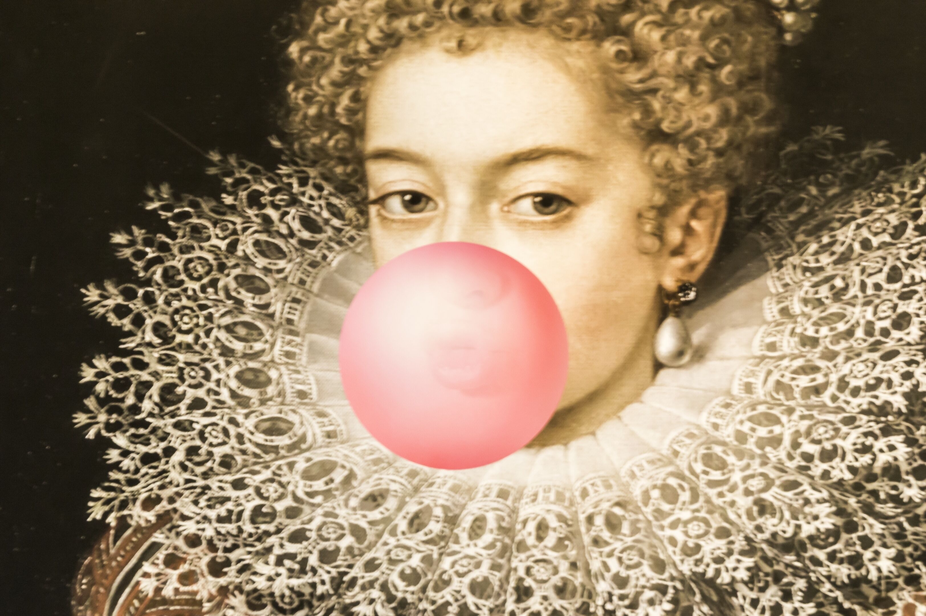 A person with curly hair wearing a detailed lace collar.