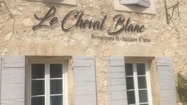 A building with the sign "Le Cheval Blanc" indicating a restaurant and cheese shop. - Le Cheval Blanc (La Bastide-des-Jourdans)
