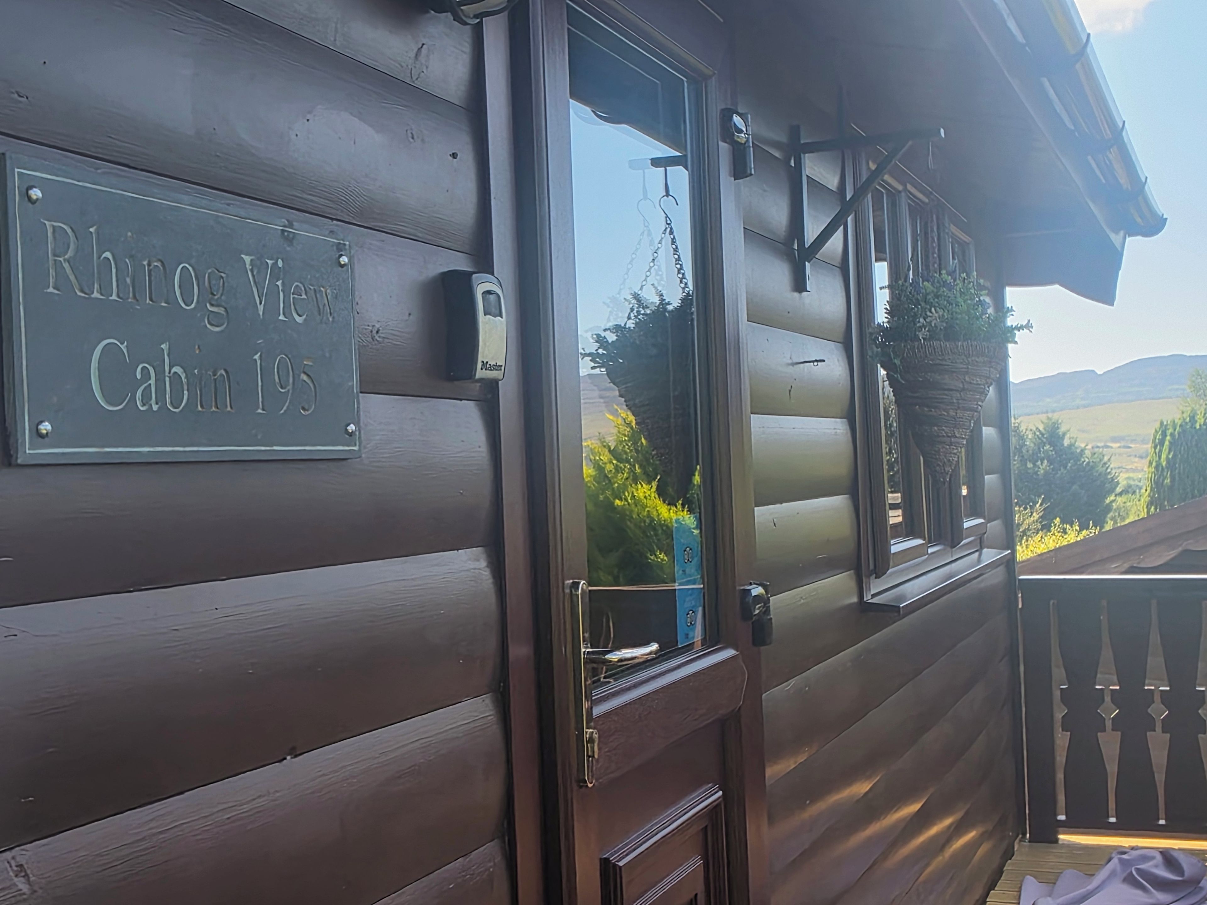 A wooden cabin with a sign reading 'Rhino View Cabin 19S'.