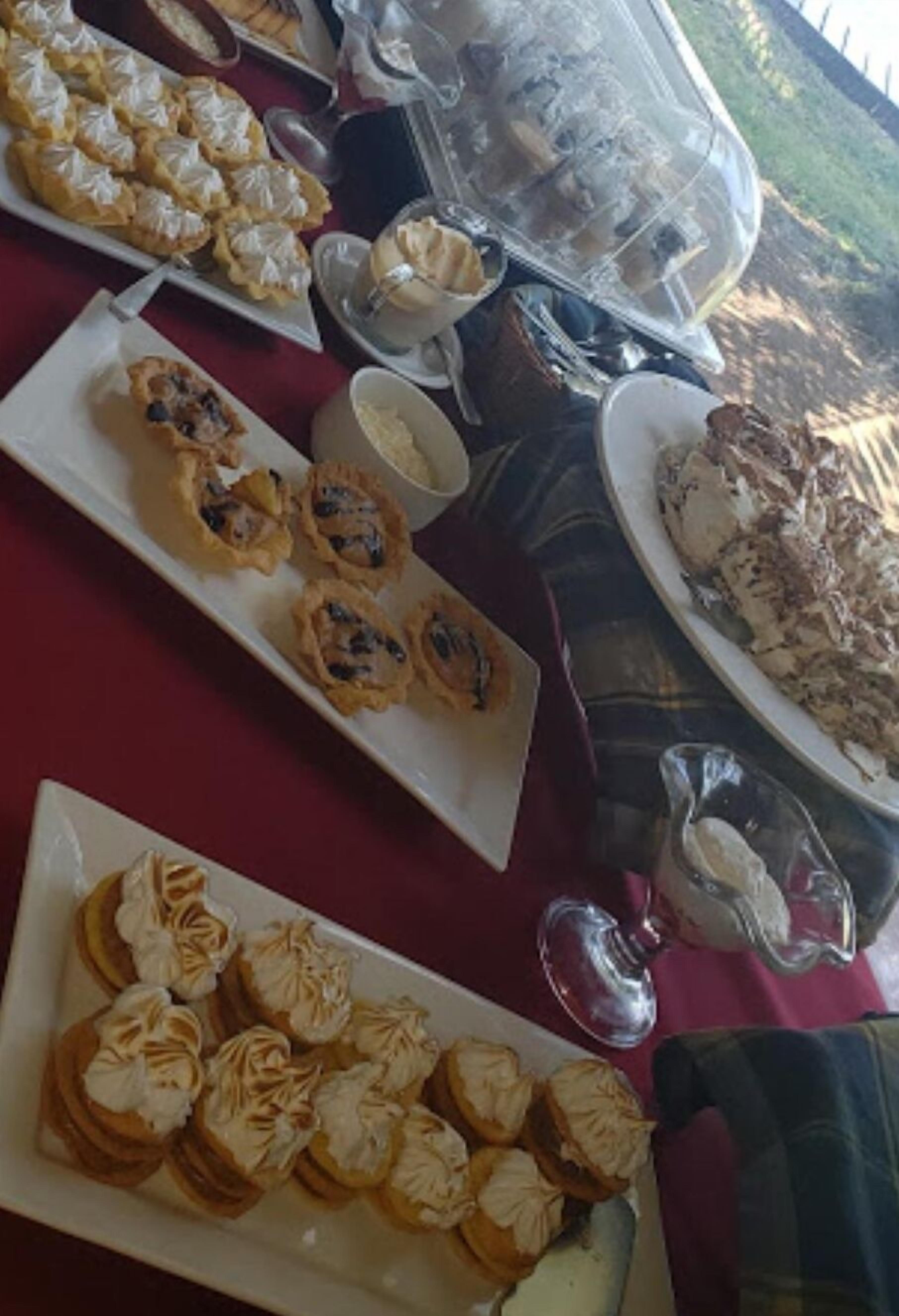 A buffet table with various desserts and pastries.