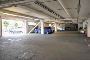 A multi-level parking garage with several cars parked.
