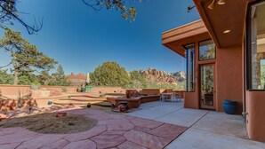 A patio with stone flooring, outdoor furniture, and a view of red rock formations. - Experience luxury in Sedona Painted Sky—sleeps 8 with stunning panoramic views. (Sedona)