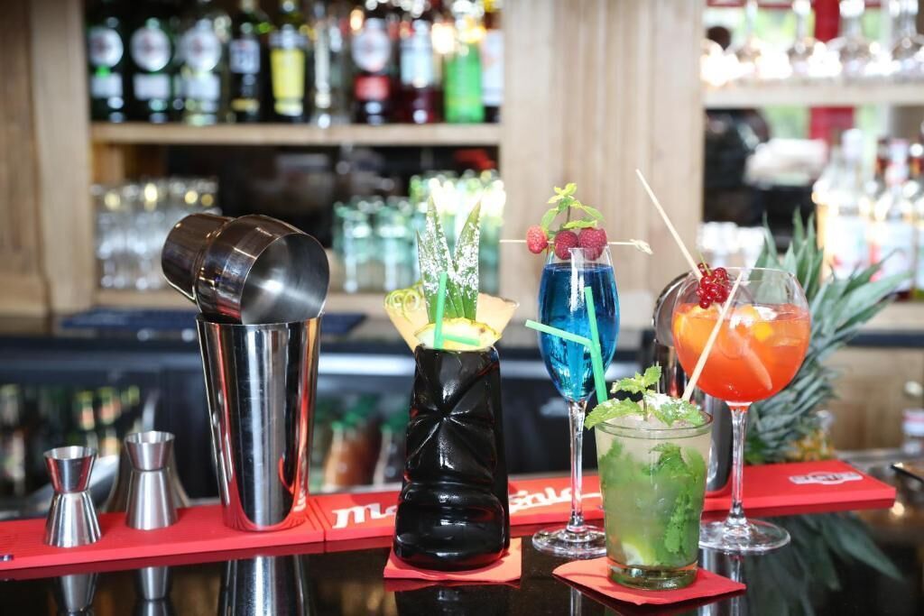 A bar area with various cocktail shakers and glasses.