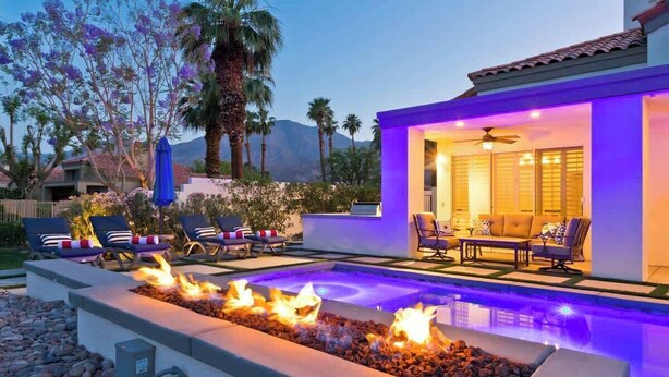 A pool area with a fire feature, outdoor seating, and a covered patio. - Casa Havana  Stunning Views Pool Spa PGA West 4br (La Quinta)