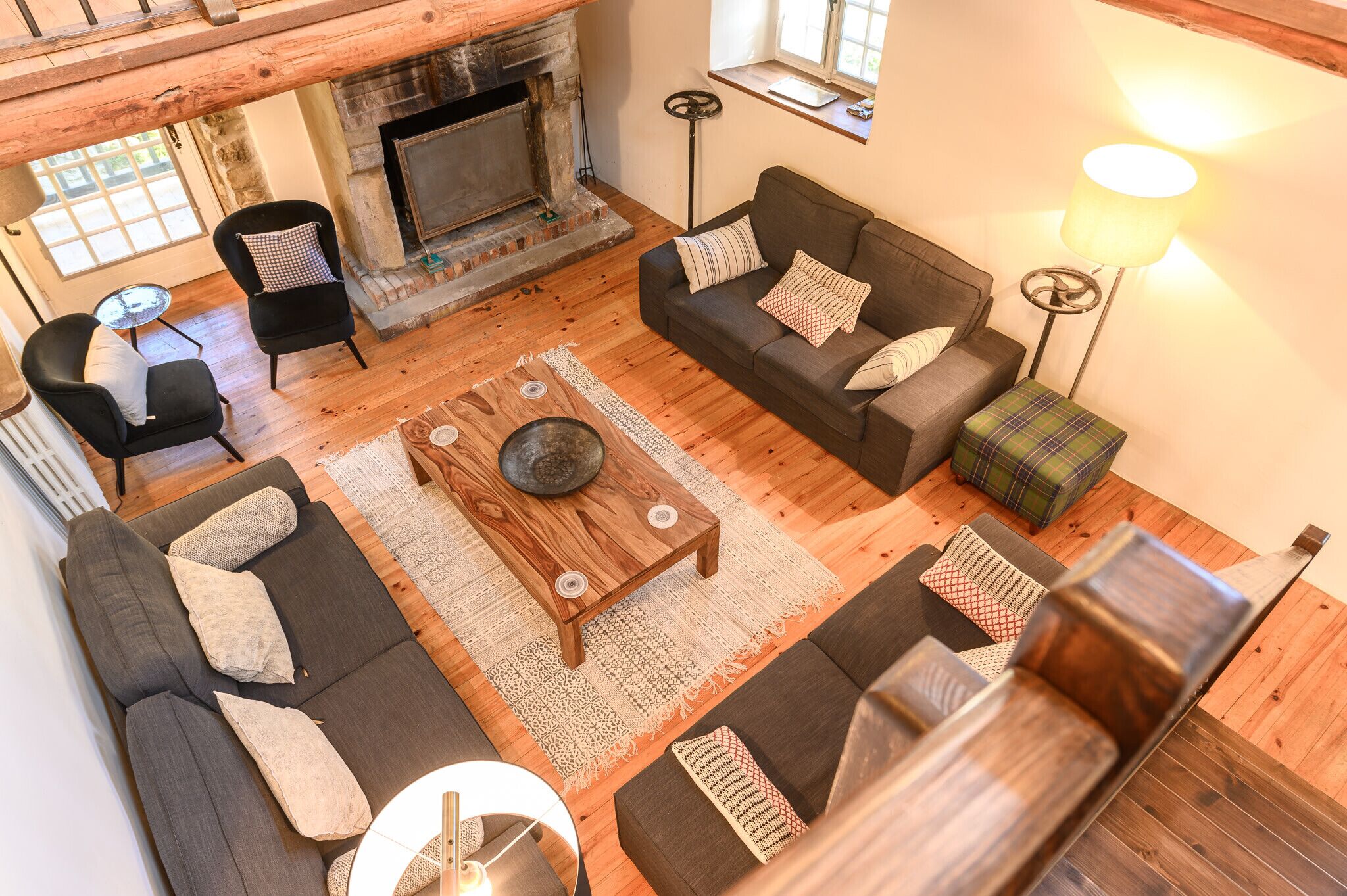 A cozy living room with a fireplace, sofas, and a coffee table.