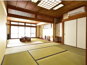 Experience the tranquility of a traditional Japanese-style room with tatami flooring, sliding doors, and a skylight.