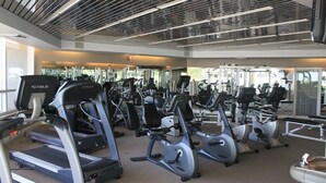 Ein Fitnessstudio mit Laufbändern, Crosstrainern und Krafttrainingsgeräten.