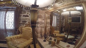 A luxurious room with a large mirror, ornate furniture, and a stone wall. - Apartment with 2 bedrooms with hot tub and water bed (Kotor)
