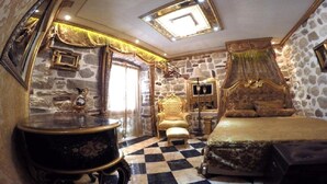 A room with a checkered floor, a bed, a chair, a lamp, and a decorative wall. - Apartment with 2 bedrooms with hot tub and water bed (Kotor)