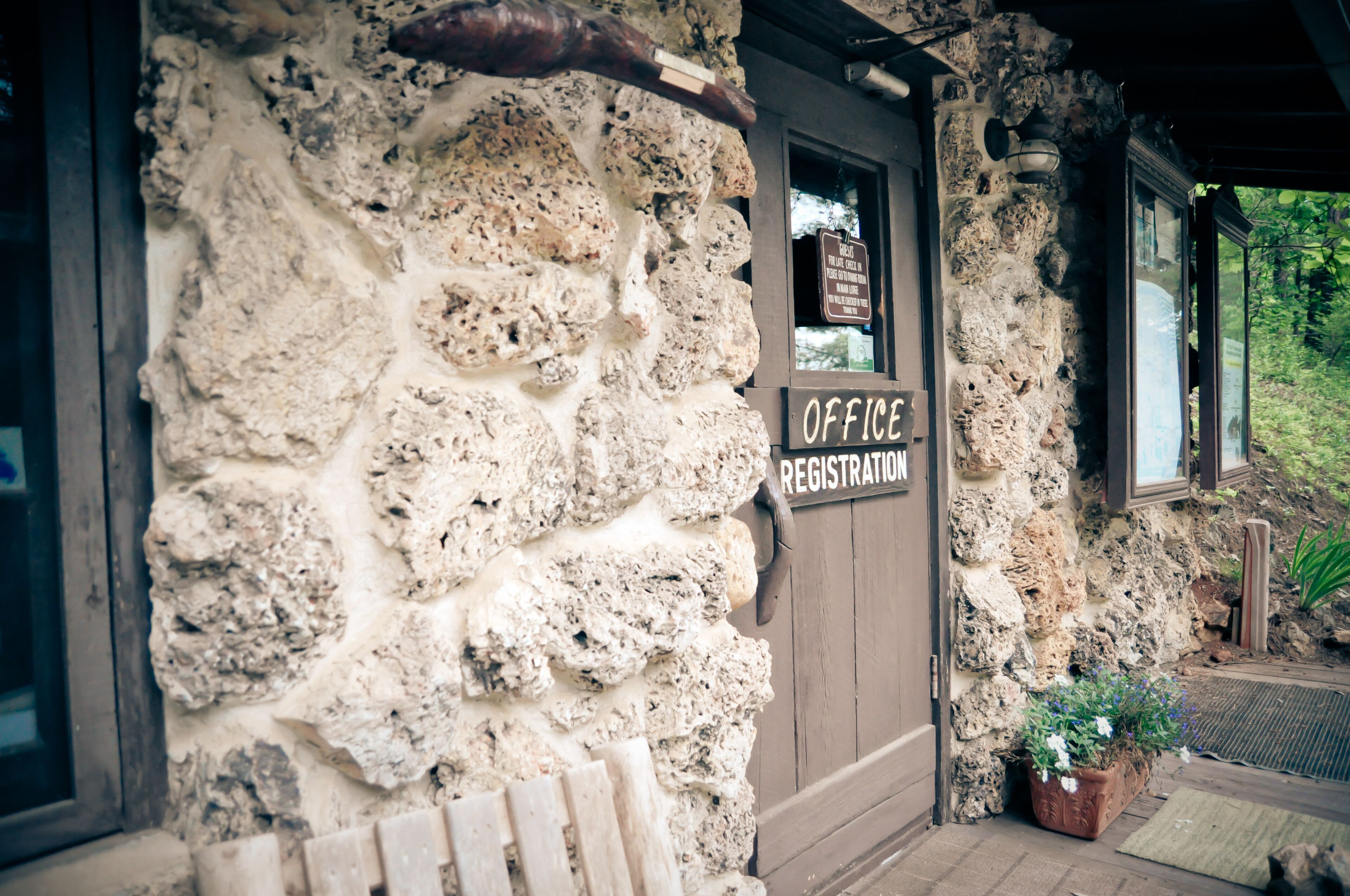 A stone building with an 'Office Registration' sign.