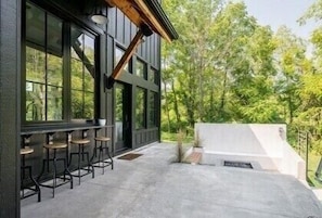 Enjoy al fresco dining on the patio with a barbecue grill and comfortable seating.