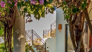 A staircase with wrought iron railings leading to a room with a large window. - Vista Hermosa (Santa María Huatulco)