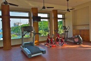 A gym with treadmills, stationary bikes, and an elliptical machine.