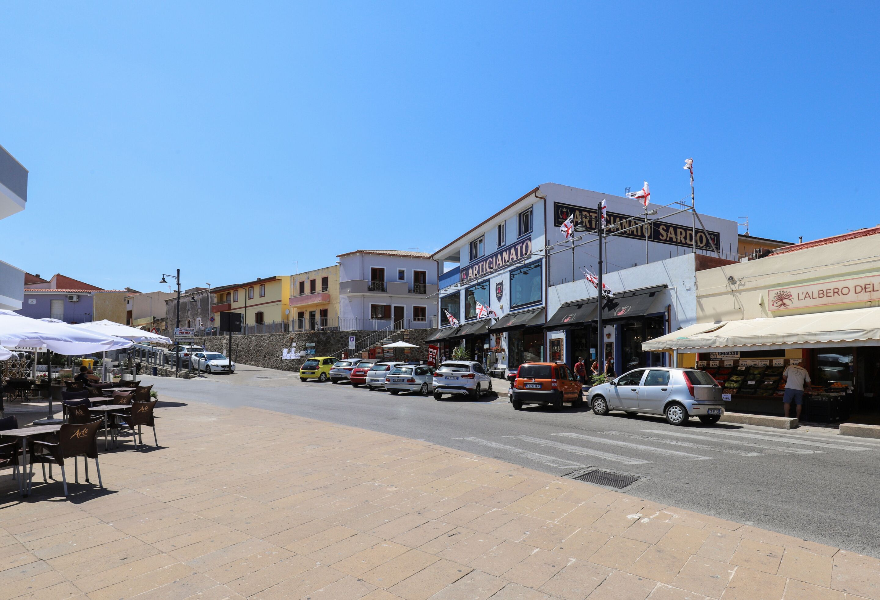 A street with shops and outdoor seating.