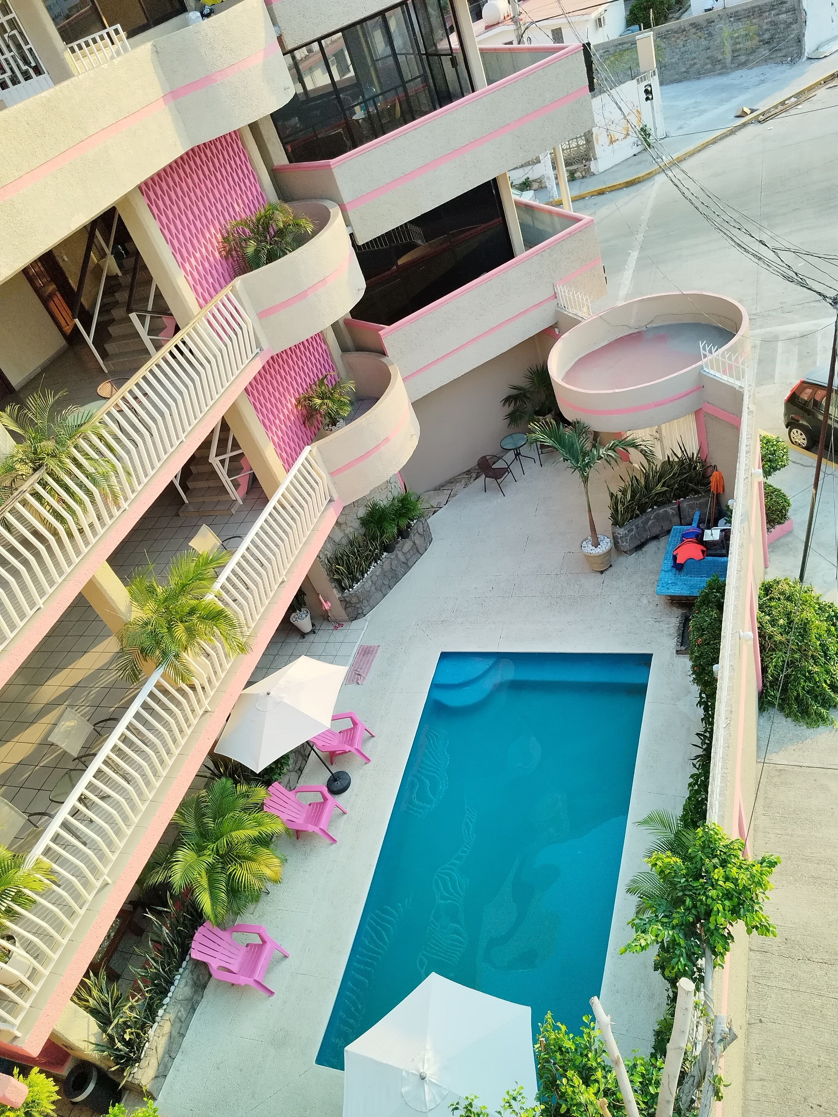 Outdoor pool, open 8:00 AM to 8:00 PM, pool umbrellas