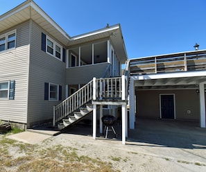 A two-story house with a covered front porch, a staircase leading to the second floor, and a garage.