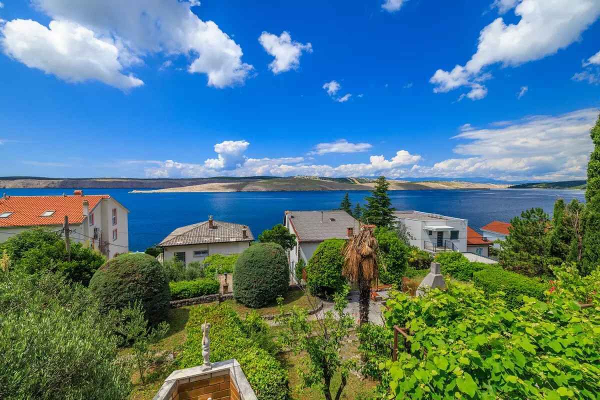 A coastal village with houses overlooking a large body of water.